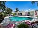 Inviting backyard pool area with lounge chairs and lush greenery at 506 69Th St, Holmes Beach, FL 34217