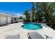 Beautiful backyard pool area with lush tropical landscaping and seating at 506 69Th St, Holmes Beach, FL 34217