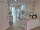 Well-equipped kitchen with white cabinets at 7636 Bergamo Ave, Sarasota, FL 34238