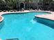 Inviting community pool with surrounding lounge chairs at 5146 Northridge Rd # 201, Sarasota, FL 34238