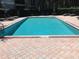Rectangular pool with surrounding lounge chairs at 5146 Northridge Rd # 201, Sarasota, FL 34238