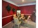 Charming dining room with glass table and red walls at 5146 Northridge Rd # 201, Sarasota, FL 34238