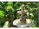 Serene garden fountain with stone sculptures and lush foliage at 3225 Duncan Way, Sarasota, FL 34239