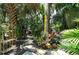 Landscaped garden path with tropical plants and stone walkway at 3225 Duncan Way, Sarasota, FL 34239