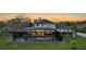 A scenic aerial view of the house, pool and screened in lanai at sunset at 6722 Oakmont Way, Lakewood Ranch, FL 34202