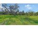Expansive backyard with a mature tree providing ample shade and lush green grass at 6722 Oakmont Way, Lakewood Ranch, FL 34202