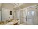 Bright bathroom featuring a glass enclosed shower, granite countertop and a decorative mirror at 6722 Oakmont Way, Lakewood Ranch, FL 34202