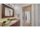 Bathroom featuring a marble vanity top, framed mirror and access to shower and toilet at 6722 Oakmont Way, Lakewood Ranch, FL 34202