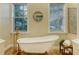 Classic bathroom with a freestanding tub, stylish fixtures, and abundant natural light from dual windows at 6722 Oakmont Way, Lakewood Ranch, FL 34202