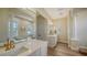 Luxurious bathroom with double vanity sinks, a standalone tub, and natural light from the large windows at 6722 Oakmont Way, Lakewood Ranch, FL 34202