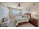 Comfortable bedroom with a bed, windows, and a ceiling fan creating a bright and welcoming atmosphere at 6722 Oakmont Way, Lakewood Ranch, FL 34202