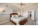 Cozy bedroom with a bed, ceiling fan, and doorway, offering a peaceful retreat at 6722 Oakmont Way, Lakewood Ranch, FL 34202