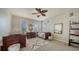 Bright bedroom featuring twin beds, neutral walls, and decorative mirrors create a calm and inviting space at 6722 Oakmont Way, Lakewood Ranch, FL 34202