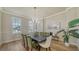 Formal dining room with hardwood floors, chandelier, and large windows with bright natural light at 6722 Oakmont Way, Lakewood Ranch, FL 34202