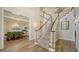 Elegant foyer with hardwood floors, staircase, chandelier, and view into the dining room at 6722 Oakmont Way, Lakewood Ranch, FL 34202