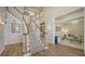 Spacious foyer with hardwood floors, staircase, and view into the living room at 6722 Oakmont Way, Lakewood Ranch, FL 34202