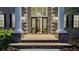 Elegant entryway boasting tall columns, a brick walkway, and a grand front door with sidelights at 6722 Oakmont Way, Lakewood Ranch, FL 34202