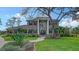Elegant two-story brick home featuring a manicured lawn, mature landscaping, and grand entryway at 6722 Oakmont Way, Lakewood Ranch, FL 34202