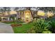 Charming brick home with a lush green lawn, tasteful landscaping, and a welcoming front entrance at 6722 Oakmont Way, Lakewood Ranch, FL 34202