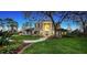 Charming two-story home with brick facade, grand entrance, manicured lawn, and mature trees at 6722 Oakmont Way, Lakewood Ranch, FL 34202