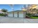 Spacious three car garage with stone accents, providing ample parking and storage space at 6722 Oakmont Way, Lakewood Ranch, FL 34202
