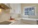 Modern kitchen features white countertops, white cabinets, and stainless steel appliances, lit by natural light at 6722 Oakmont Way, Lakewood Ranch, FL 34202