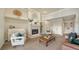 Comfortable living room with fireplace, piano, built-in shelving, and neutral decor at 6722 Oakmont Way, Lakewood Ranch, FL 34202