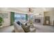 Comfortable living room with a brick fireplace, large windows, and cozy seating arrangements at 6722 Oakmont Way, Lakewood Ranch, FL 34202
