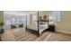 Spacious main bedroom with a four-poster bed, sitting area, and large windows at 6722 Oakmont Way, Lakewood Ranch, FL 34202