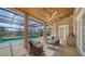 Outdoor patio with stylish seating and a view of the screened-in pool and the backyard at 6722 Oakmont Way, Lakewood Ranch, FL 34202
