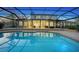 A beautiful pool with a screen enclosure reflecting the home's back exterior and patio at 6722 Oakmont Way, Lakewood Ranch, FL 34202