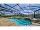 Inviting in-ground pool within a screened enclosure, surrounded by lush landscaping at 6722 Oakmont Way, Lakewood Ranch, FL 34202