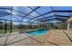 Backyard features a screened-in pool and patio overlooking the beautiful green space at 6722 Oakmont Way, Lakewood Ranch, FL 34202