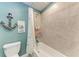 Clean bathroom with a tub, shower, and nautical-themed decor at 5311 Coral Reef Way, Bradenton, FL 34211