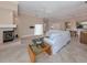 Bright living room with a fireplace, tiled floors and white couch at 424 Cardiff Rd # 27, Venice, FL 34293