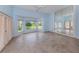 Bright bedroom with light blue walls, tile floors, and large windows at 424 Cardiff Rd # 27, Venice, FL 34293