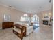 Open living room with fireplace, tiled floors, and access to patio at 424 Cardiff Rd # 27, Venice, FL 34293