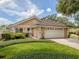 Single story home with a two-car garage and lush landscaping at 424 Cardiff Rd # 27, Venice, FL 34293
