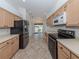 Eat-in kitchen with stainless steel appliances and light wood cabinets at 424 Cardiff Rd # 27, Venice, FL 34293
