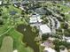 Aerial view of single Gathering home near golf course and pond at 424 Cardiff Rd # 27, Venice, FL 34293
