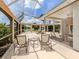 Relaxing screened lanai with outdoor furniture and water views at 424 Cardiff Rd # 27, Venice, FL 34293