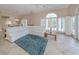 Spacious living room with tiled floors, white couch and large windows at 424 Cardiff Rd # 27, Venice, FL 34293