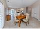 Bright dining room with wooden table and chairs, near living room at 424 Cardiff Rd # 27, Venice, FL 34293