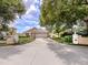 Single-story home with a two-car garage and manicured landscaping at 424 Cardiff Rd # 27, Venice, FL 34293