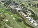 Aerial view of community near golf course and water at 424 Cardiff Rd # 27, Venice, FL 34293