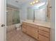Clean bathroom with light wood cabinets and tile flooring at 424 Cardiff Rd # 27, Venice, FL 34293