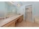 Double vanity bathroom with a walk-in shower and a separate tub at 424 Cardiff Rd # 27, Venice, FL 34293