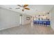Open living room features tile floors and a view into the kitchen with a breakfast bar at 11415 52Nd E Ct, Parrish, FL 34219