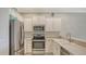 Well-equipped kitchen featuring stainless steel appliances and white cabinets at 11415 52Nd E Ct, Parrish, FL 34219