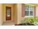 House exterior with red door and brown shutters at 11415 52Nd E Ct, Parrish, FL 34219